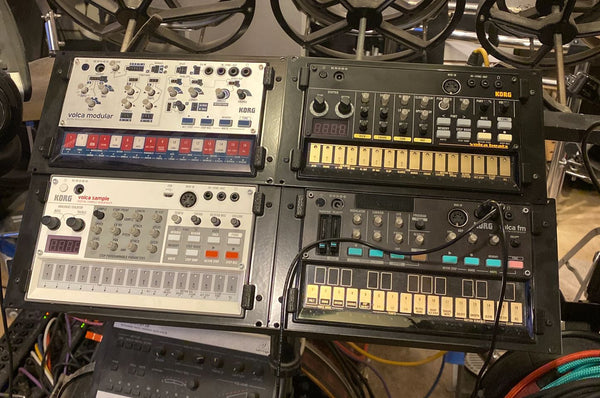 Four Korg Volcas mounted in Eurorack frame adapters.